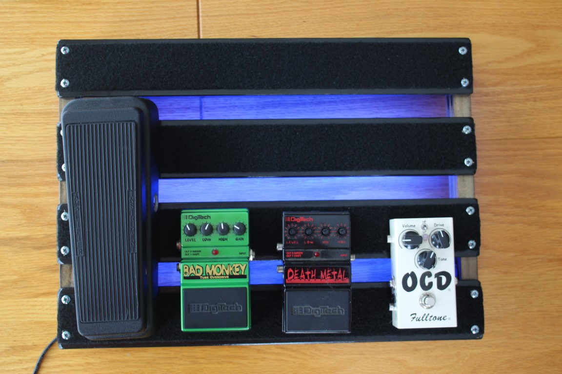 Top view of the Under-Glowed 18x13inch Hand Made PedalBoard with bad monkey, death metal, and OCD fulltone pedals