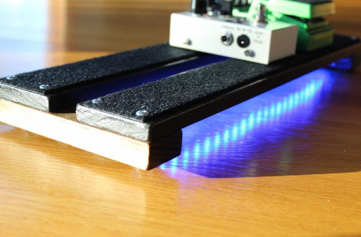 Side view of the Under-Glowed 18x6inch PedalBoard with Fulltone OCD and Bad monkey pedals